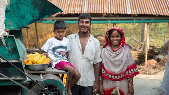 A family in the southern Bangladesh district of Rangpur stop to pose near farming machinery as part of their participation in BRAC's Ultra-Poor Graduation program (BRAC 2021)